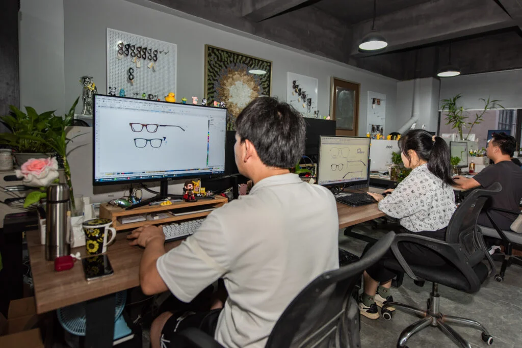 DMARJAN eyewear development team preparing technical drawings